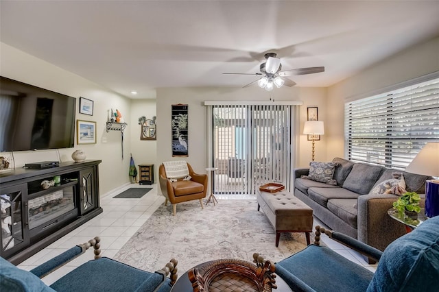 living room featuring ceiling fan and light tile patterned floors