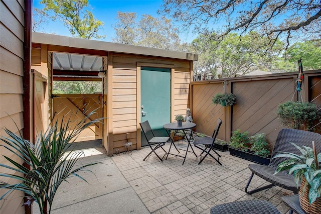 view of patio featuring a fenced backyard and an outbuilding