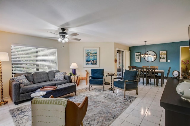 living room featuring ceiling fan with notable chandelier and light tile patterned floors