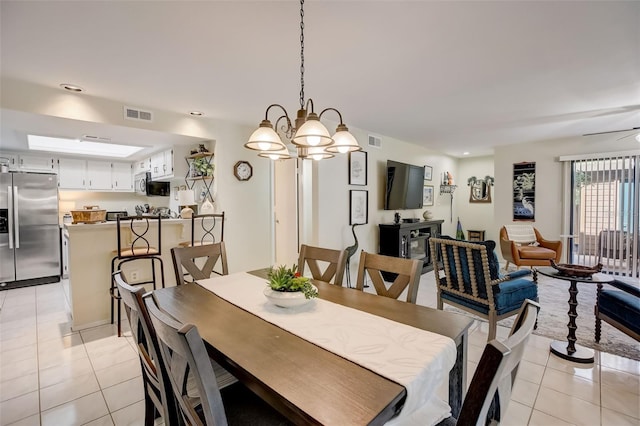 dining space with light tile patterned floors, visible vents, and recessed lighting