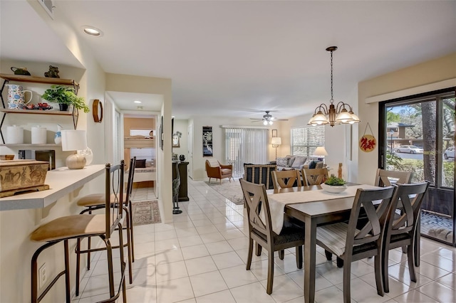 dining area with recessed lighting, an inviting chandelier, and light tile patterned floors