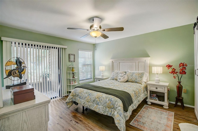 bedroom featuring wood finished floors, a ceiling fan, and baseboards