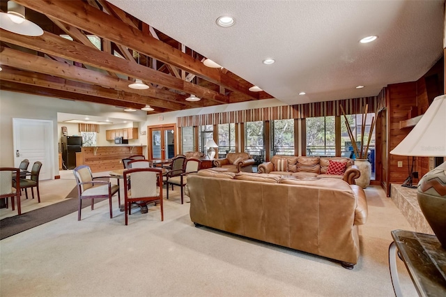 living room featuring recessed lighting, light colored carpet, and a textured ceiling