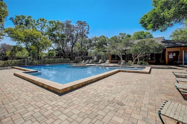 pool featuring a patio area and fence