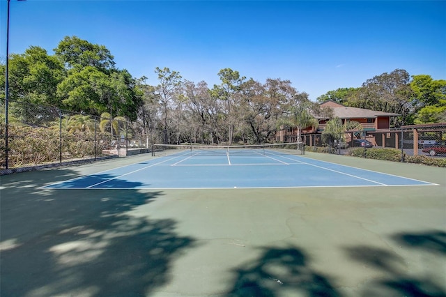 view of sport court featuring fence