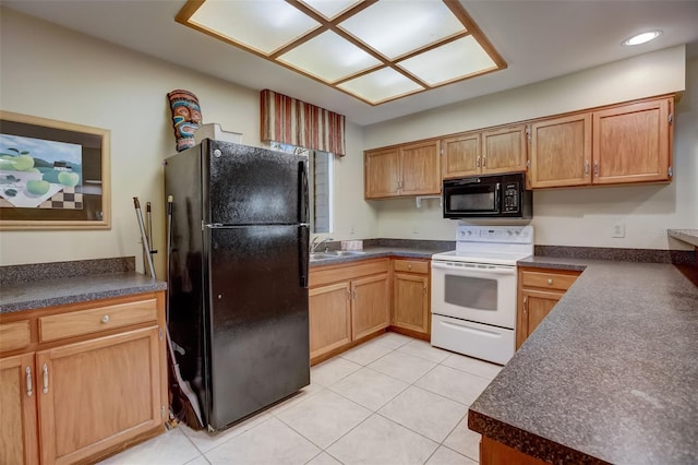 kitchen with dark countertops, a sink, black appliances, and light tile patterned floors