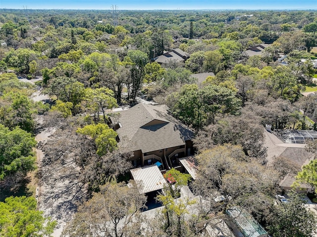 birds eye view of property with a view of trees