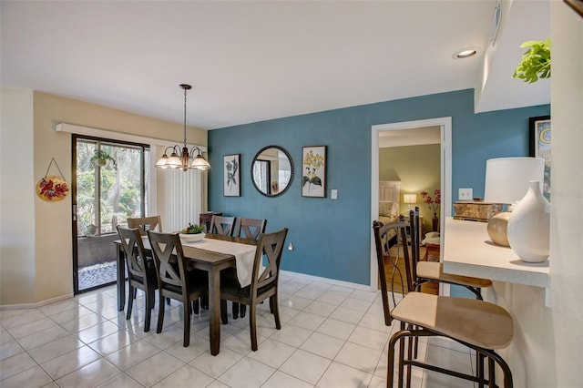 dining area featuring light tile patterned floors, baseboards, and a chandelier