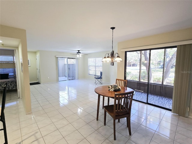 dining space featuring light tile patterned flooring, ceiling fan, and baseboards