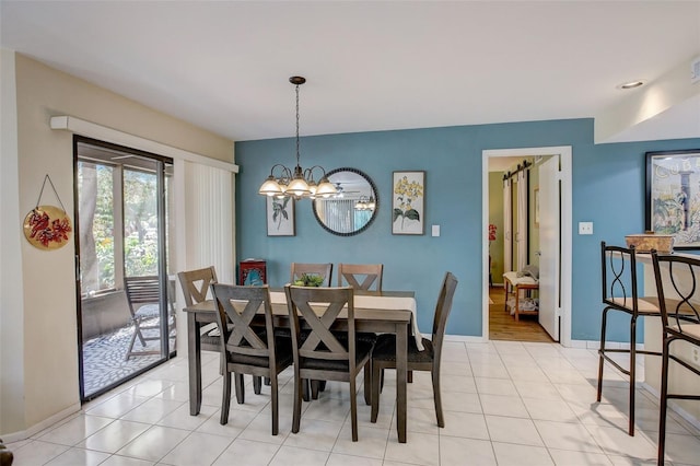 dining area featuring light tile patterned floors, baseboards, and an inviting chandelier