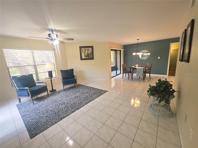 103 Cypress Pond Rd Unit 103, Palm Harbor, FL 34683 - sitting room with baseboards, visible vents, light tile patterned floors, and ceiling fan with notable chandelier