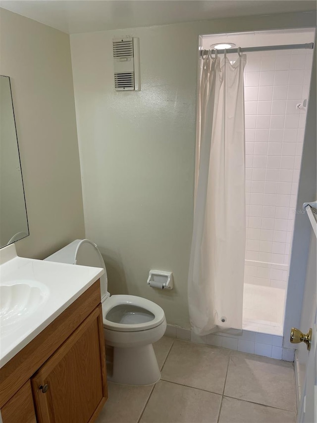 bathroom with tile patterned floors, walk in shower, vanity, and toilet