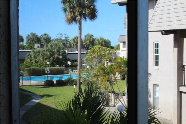 view of pool featuring a lawn