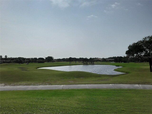 view of home's community featuring a yard and a water view