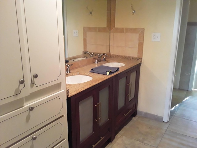 bathroom with tile patterned floors, double vanity, and a sink