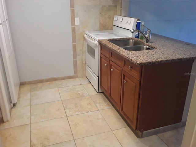 kitchen with white range with electric cooktop, light tile patterned flooring, stone countertops, tile walls, and a sink