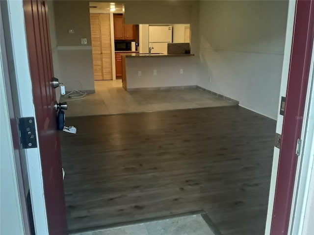 interior space with light wood finished floors and a sink