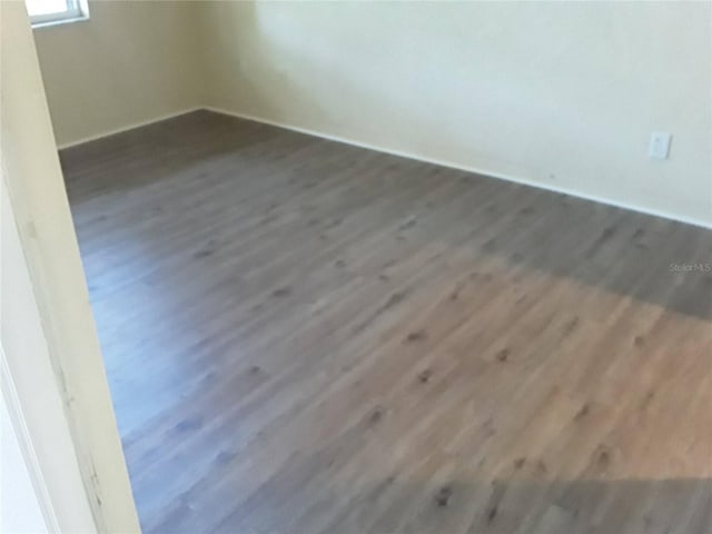 spare room with wood finished floors