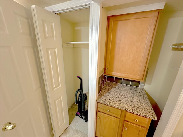 interior space featuring tile patterned flooring and backsplash