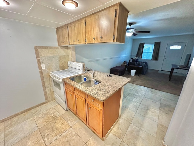 kitchen featuring ceiling fan, light colored carpet, brown cabinetry, white electric range, and a sink