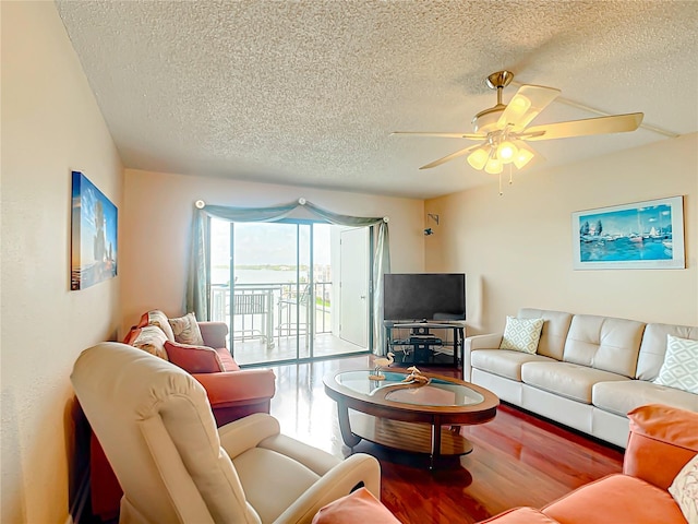 living room featuring a textured ceiling, ceiling fan, and hardwood / wood-style flooring