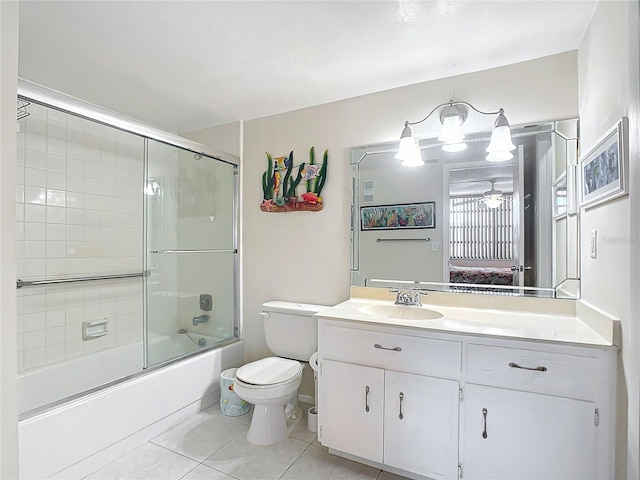 full bathroom with tile flooring, toilet, oversized vanity, and combined bath / shower with glass door