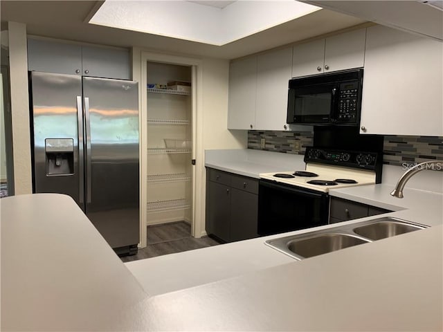 kitchen with electric stove, tasteful backsplash, stainless steel refrigerator with ice dispenser, and dark hardwood / wood-style floors