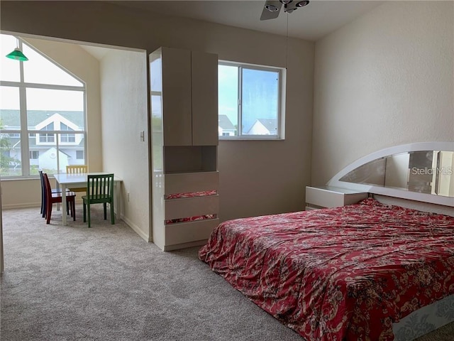 bedroom with light carpet and ceiling fan