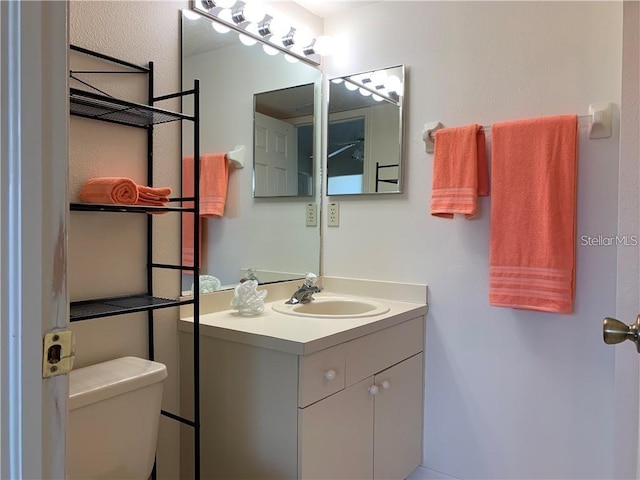 bathroom featuring toilet and vanity