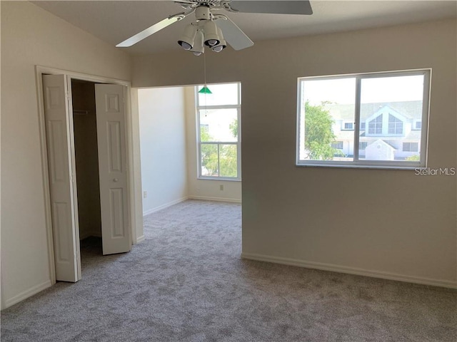 unfurnished bedroom with a closet, ceiling fan, and light colored carpet