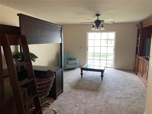 interior space with light carpet, a textured ceiling, and ceiling fan