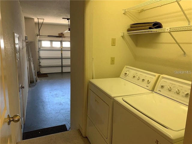 clothes washing area with washer and clothes dryer