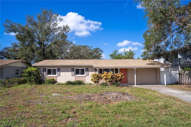 single story home with a garage and a front lawn