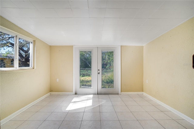 tiled empty room with french doors