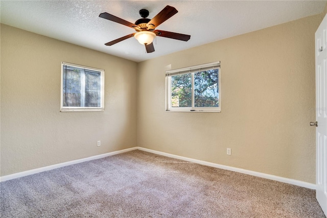 carpeted empty room featuring a textured ceiling and ceiling fan