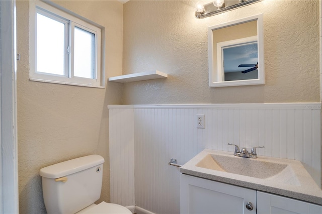 bathroom with vanity, ceiling fan, and toilet