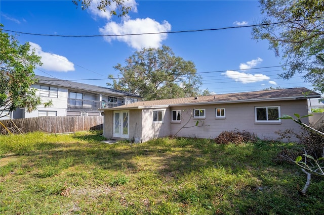 rear view of property with a yard