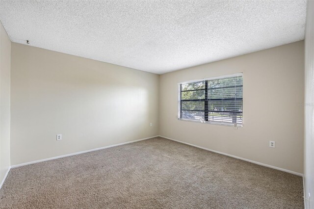 empty room featuring carpet flooring and a textured ceiling