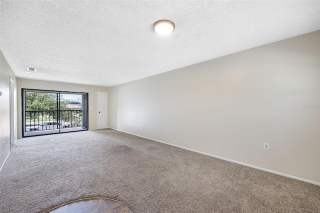 unfurnished room with a textured ceiling and carpet