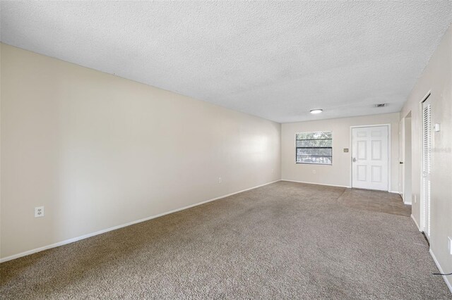 101 Lake Ave NE Unit 225, Largo, FL 33771 - carpeted empty room featuring baseboards and a textured ceiling