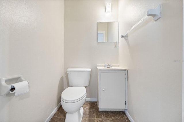 101 Lake Ave NE Unit 225, Largo, FL 33771 - bathroom with baseboards, toilet, and vanity