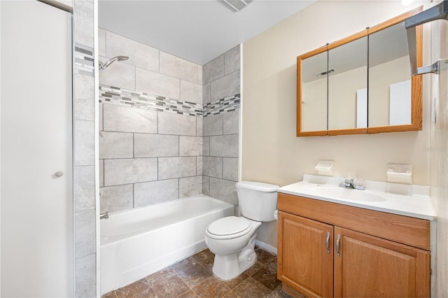 full bathroom featuring tiled shower / bath combo, vanity, and toilet