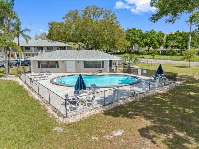 view of pool featuring a patio area and a lawn