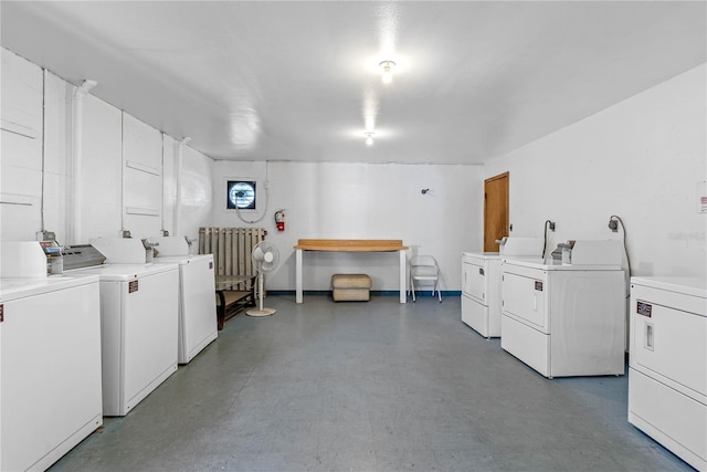 laundry room featuring radiator and washer and dryer