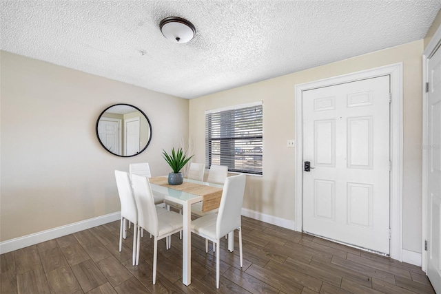 dining room featuring dark hardwood / wood-style floors and a textured ceiling