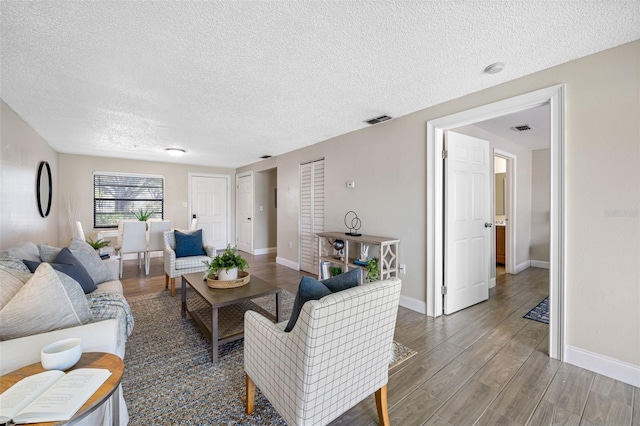 living room featuring dark hardwood / wood-style floors and a textured ceiling