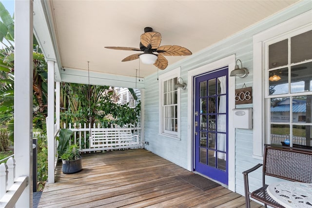 wooden terrace featuring ceiling fan