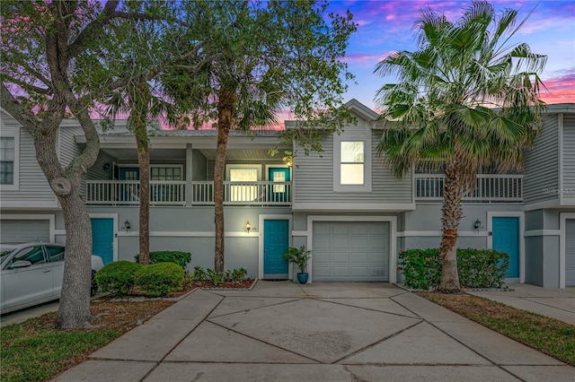 view of property featuring a garage and a balcony