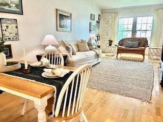 living room with light hardwood / wood-style floors and lofted ceiling