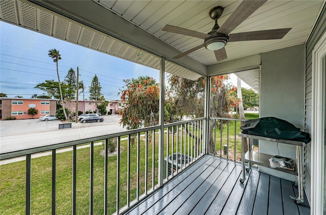 deck with ceiling fan and a yard